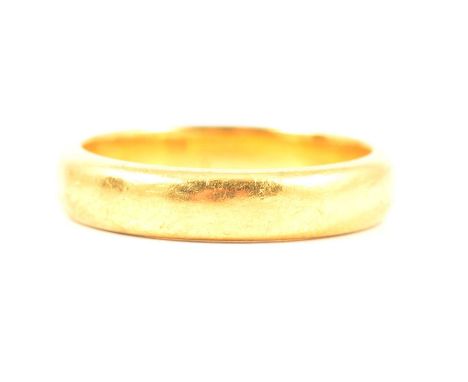 A yellow metal wedding band stamped 22ct, 4mm wide plain polished half D shape, ring size K, not hallmarked, 5.6g;