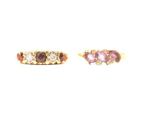 A garnet and diamond ring, the three round brilliant cut garnets ranging from approx. 3.5mm to 2.75mm diameter claw set, with