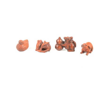 Four Japanese wooden netsuke, including a single rabbit, signed 4.5cm long; two rabbits eating a carrot, 4cm; a rodent with a