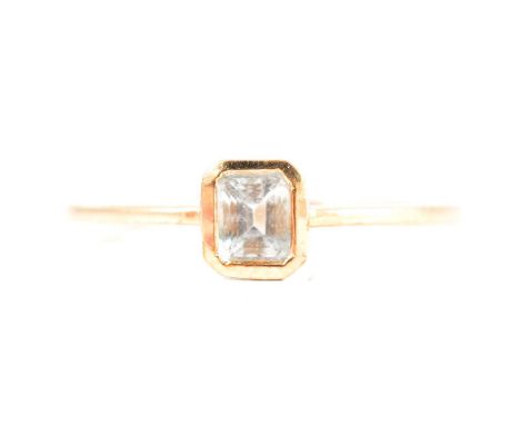 Gemporia - an aquamarine ring, the octagon cut stone, 5x4mm, collet set in a 9 carat yellow gold mount ring size R, aquamarin