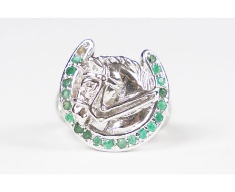 Silver horse shoe ring set with emeralds 