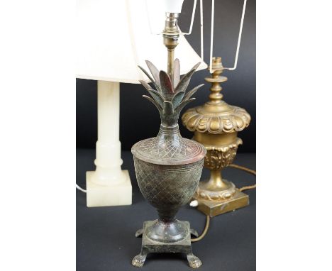Group of three 20th Century lamp bases to include an aged metal pineapple lamp base raised on paw feet, gilt metal lamp base 