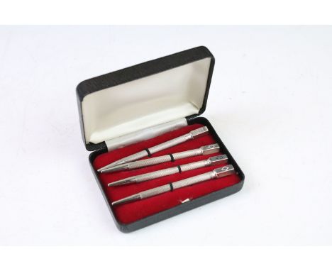 Set of Four cased Sterling Silver ‘ Bridge ‘ Propelling Pencils, each with a square finial marked with the suites and engine 
