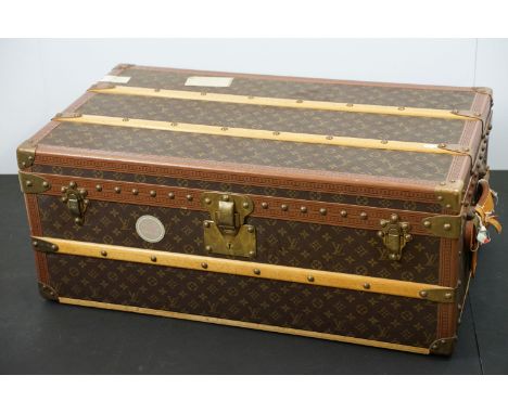 Louis Vuitton - Monogrammed canvas travel trunk having branded leather banding, wooden slats, brass lock with flip lock clasp