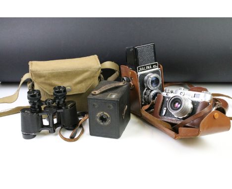 Pair of military binoculars to include a marked 'militaire' set within a green canvas case with crows foot mark, a USSR film 