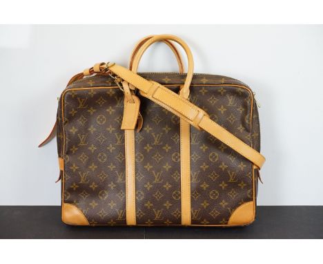 Louis Vuitton - Porte documents voyage briefcase bag having monogramed body with tan leather handles and shoulder strap. Meas