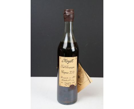 A bottle of Moyet fine champagne Cognac X. O. Bottle Number 1474 of 1930. 0,70l, 40% vol. Sealed. 