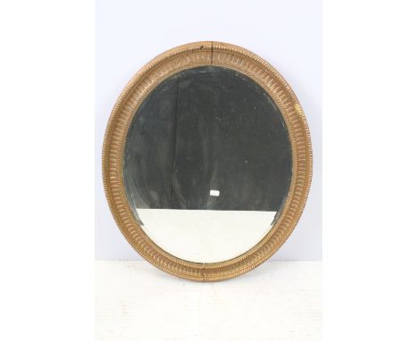Bevelled glass mirror of oval form with oval painted plaster frame 
