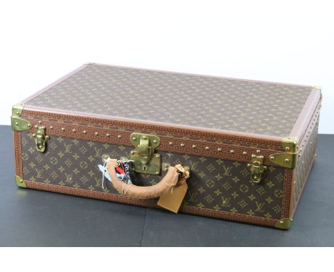 Louis Vuitton - Monogrammed canvas trunk with brass fittings and lock, opening to reveal beige interior complete with cream l
