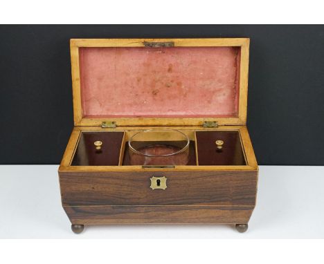 Late 19th / early 20th century rosewood sarcophagus tea caddy, the lid opening two two lidded compartments and glass mixing b