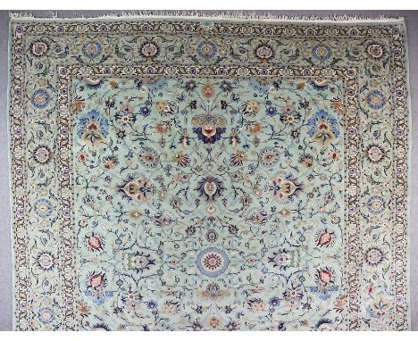 A Tabriz Carpet, Early 20th Century, woven in pale blue, dark blue fawn and ivory with palmettes and trailing leaf ornaments,
