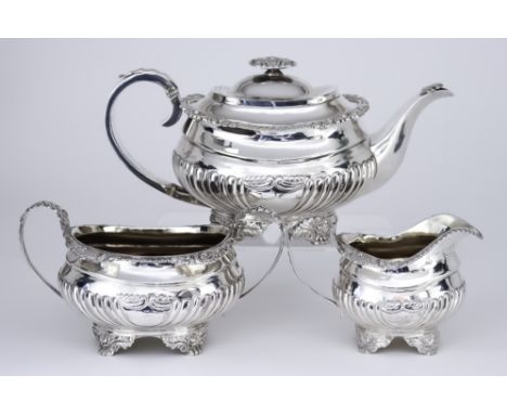 A George IV Silver Three-Piece Tea Service, by Hyam Hyams, London 1821, the rectangular partly reeded bodies with cast shell,