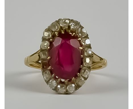 A Ruby and Diamond Ring, Early 20th Century, in gold colour metal mount, set with central faceted ruby, approximately 2.5ct, 