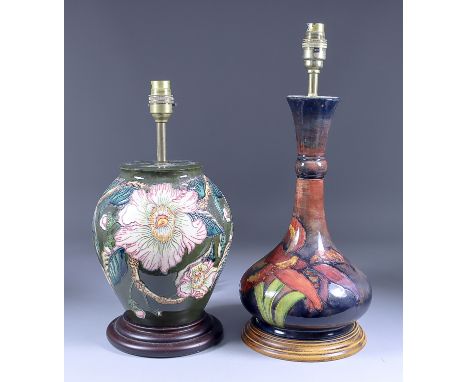 A Moorcroft Pottery Table Lamp with a full blown flower and leaf design, on turned wood base, 13.75ins overall, and a table l