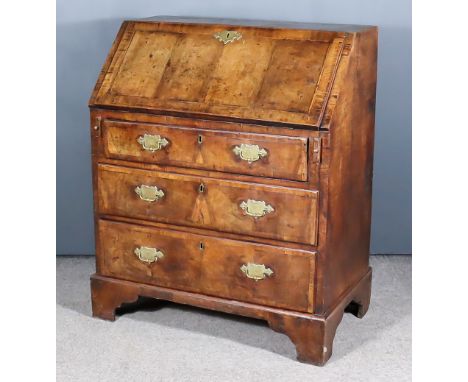 A Mid 18th Century Walnut Bureau of Small Proportions, the top, slope and drawer fronts veneered in matched veneer panels wit