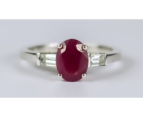 A Ruby and Diamond Ring, Modern, in 18ct white gold mount, set with a centre faceted ruby approximately 1ct, flanked by two s