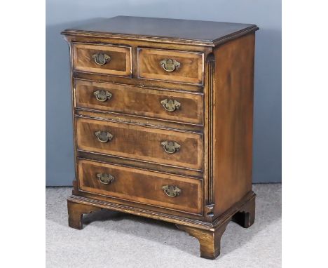 A Walnut Chest of "18th Century" Design, fitted two short and three long drawers, with fluted canted corners and on bracket f
