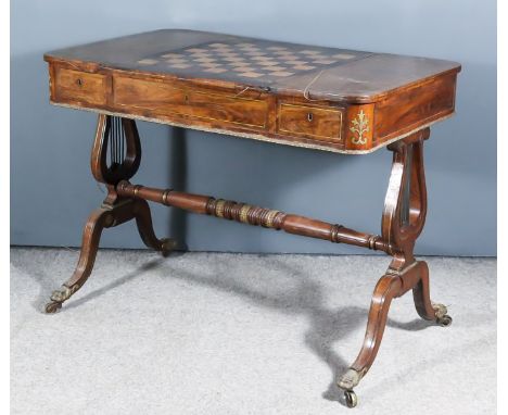 A Regency Rosewood Brass Inlay and Gilt Brass Mounted Games Table, the sliding central panel with reverse inlaid with chessbo