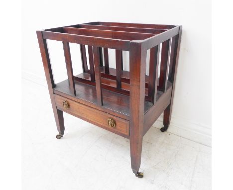 An early 19th century three-division mahogany Canterbury: single full-width drawer with lion mask and ring handles, raised on