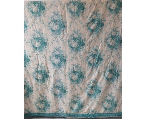 A pair of curtains in a cream and green patterned silk effect damask with a green floral print, thick green fringed edging, g