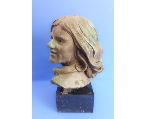 A 20th century bronzed shoulder-length female portrait bust upon a heavy marble/black granite plinth base, the sculpture date