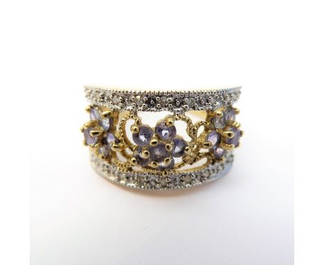 A 9-carat gold dress ring set with small tanzanites and diamonds (boxed), ring size K/L