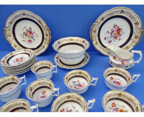 A 19th century part tea service hand-gilded and decorated in enamels with floral sprays: 2 x 25 cm cake plates; a slop bowl o