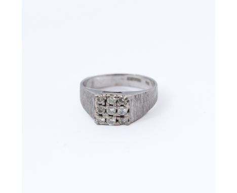 An 18-carat white gold ring set with nine diamonds, ring size M