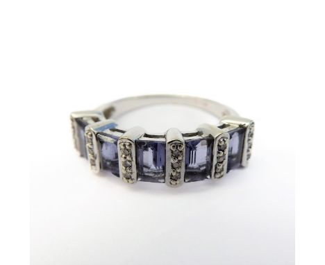 A 9-carat white gold ring set with five baguette tanzanite stones and diamonds (boxed), ring size M
