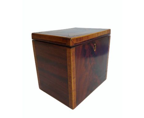 A George III period mahogany and rosewood crossbanded tea caddy of rectangular form: lined interior with pull-out tin tea con