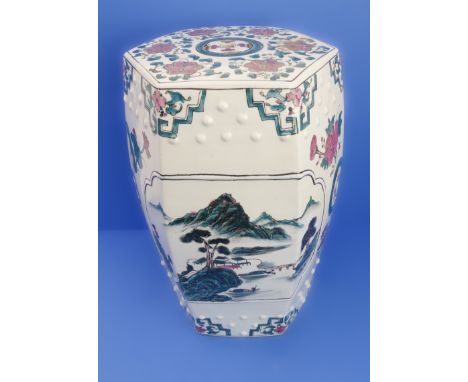 A hexagonal Chinese ceramic garden seat decorated with flowers and lanterns (32cm wide x 48cm high)