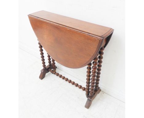 An early 20th century oval topped walnut Sutherland style table on bobbin-turned legs (81cm leaves up x 64.5cm deep x 64.5cm 