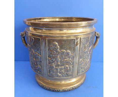 A heavy 19th century polished brass two-handled planter (probably Japanese) decorated in low relief with figures and attendan