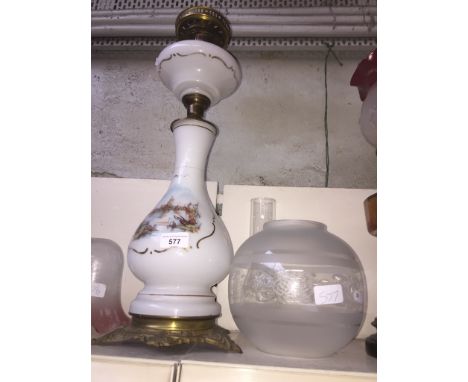 Tall milk glass oil lamp with funnel and clear glass shade 