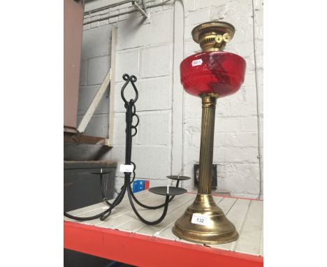 Oil lamp with brass column stem and cranberry glass well and hanging candle holder 