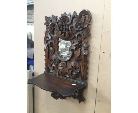 An antique carved ornate Black Forest wall/telephone shelf with mirrorCondition: age related surface wear throughout with min