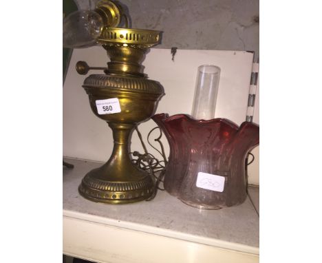 Brass converted oil lamp with funnel and pink frilled shadeCondition: no damage to shade, all glass ok, surface wear to metal