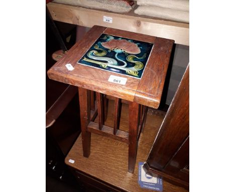 An oak plant stand with Art Nouveau inset tile, height 52cm. 