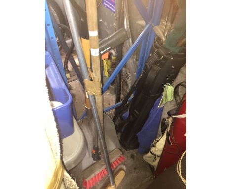 A snow shovel, 2 sweeping brushes and a pick stick 