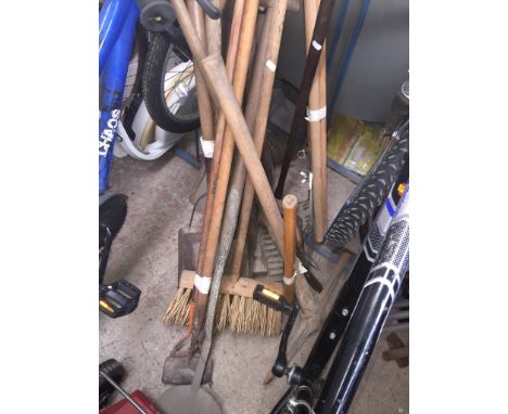 Various old garden and related tools including a pick axe, shears, hand scythe, hoes, spades, pitching forks, etc. 