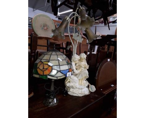 A Tiffany style lamp and a figural lamp. 
