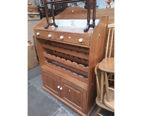 A pine kitchen cabinet with tile back, wine storage and lower cabinet. 