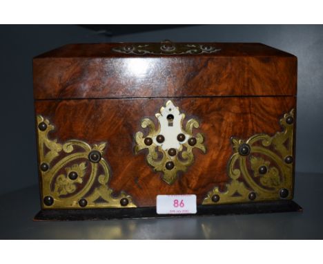 A 19th Century walnut tea caddy, having brass decoration, two interior compartments , approx. width 24cm
Slight chips to the 