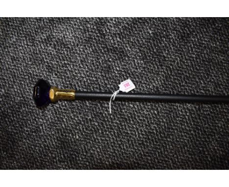 A bridges walking cane or swagger stick having embossed metal handle.