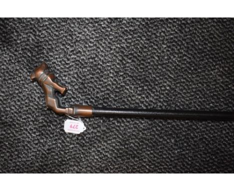 A bridges walking cane or swagger stick having metal bull dog handle.