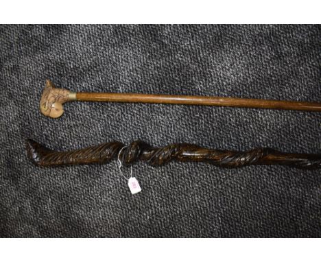 A walking cane having carved cobra detailing, also a vintage cane having a parrot head to handle.&nbsp;
Condition report no c