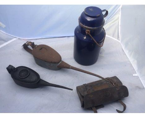 A blue enamel container, two oil cans and a leather satchell.
