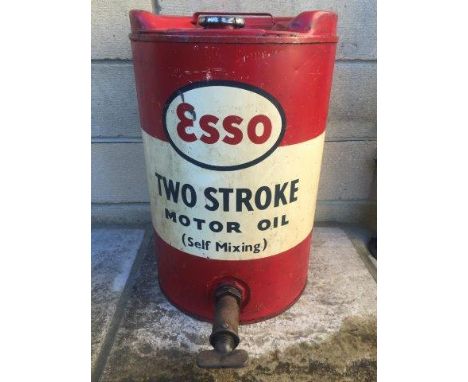 An Esso Two Stroke Motor Oil (self mixing) five gallon cylindrical drum with dispensing tap.