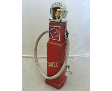 A rare Shell diecast petrol pump with battery enclosed, illuminating a Shell globe bulb, operated by winding the side handle.