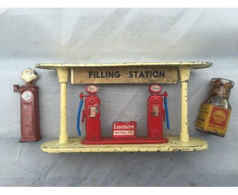 An Esso diecast filling station, an early Shell lead petrol pump and a small bottle of Shell Lubricating Oil for Tri-ang trai